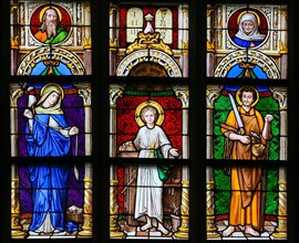 Stained Glass window in the 15th Century Elzenveld Chapel in Antwerp, Belgium, depicting Mother Mary, Jesus and Saint Joseph