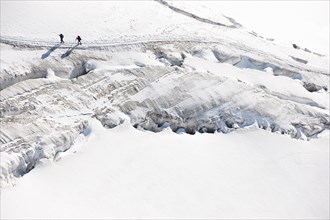 Mountaineers traversing deep snow, high angle