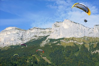 Four paramotors flying at the 2017 Coupe Icare event. Saint-Hilaire du Touvet, Isère, Auvergne-Rhône-Alpes, France.