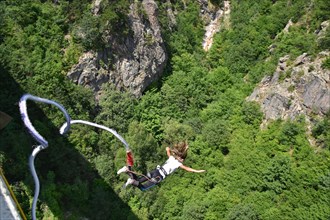 Young woman bungee jumper jumping from a 230 feet high viaduct