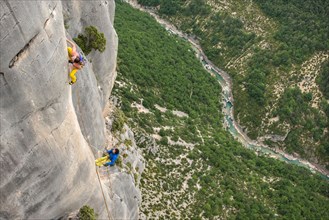 View from above of male and female rock climber climbing rock face, Verdon Gorge, Alpes-de-Haute-Provence, France