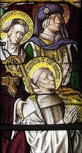 . English: Stained glass window, originally from Cistercian abbey Mariawald, representing Saint Bernard of Clairvaux with his parents Aleth (Aleidis) and Tescelin (Tesselinus); inscriptions of the nim...