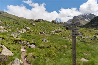 Wooden fingerpost in the French Pyrenees pointing along a footpath to the Refuge du Rulhe, Laparin and the Etangs de Fontargente, on the GR10 route.