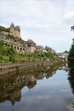 FRANCE, UZERCHE - JULY 12, 2018: Panorama of the picturesque medieval village with the river Vezere in front of it.