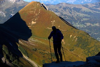 Silhouette of a mountain hiker.  Mont Blanc Massif,  French Alps.  France.