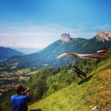 Hang glider launching above Lake Annecy in France