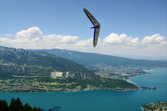 2014-06-25 Annecy; France. Hang glider pilot do extreme aerobatic maneuvers over lake Annecy. Popular place for airborne sports.