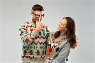 happy couple at christmas ugly sweater party