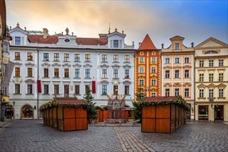 Prague, Czech Republic - Beautiful little square and traditional Czech houses of Prague with small Christmas market on a sunny afternoon. Golden cloud