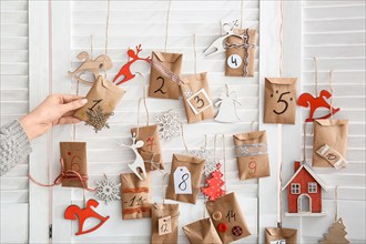 Woman making Christmas advent calendar