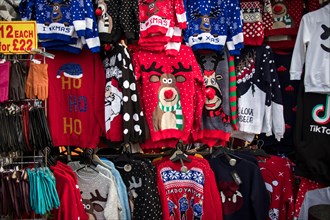 London, UK - December 2nd, 2019. A temporary seasonal display of ugly Christmas sweaters at a retail store .