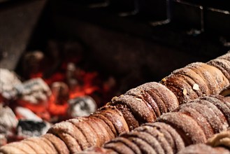 Close-up image of a typical Czech dessert called trdelnik in preparation