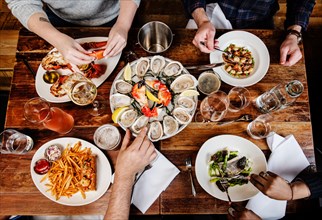 group of friends eating dinner at a seafood restaurant