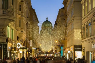 VIENNA, AUSTRIA - 2ND DECEMBER 2016: A view along Kohlmarkt in Vienna at Christmas. Lots of people, decorations and the outside of shops can be seen.