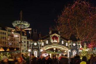 Night scenery, beautiful arched entrance of Weihnachtsmarkt, Christmas Market in Köln, at Alter Markt, famous marketplace nearby Cologne city hall.