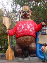 Giant bear wearing an ugly Christmas sweater at the Grizzly River Run, Disney California Adventure Park, Anaheim California, United States