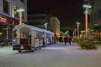 A street in Rovaniemi city with New Year and Christmas decorations in winter, Finland, Lapland. Christmas trees, ?hristmas express, New Year's illumin