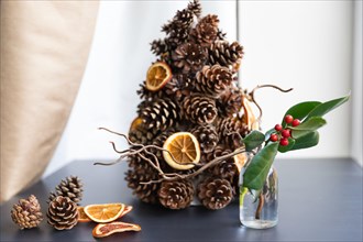 alternative Christmas tree from pine cones with dried orange slices decoration makes perfect eco zero waste decor