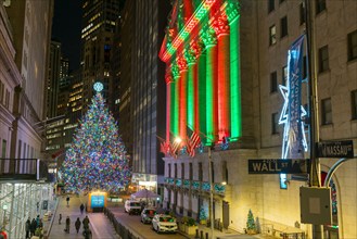 Christmas tree glows at front of NYSE during Pandemic of COVID-19 2020 NYC.