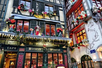 France, Alsace, Bas-Rhin, Strasbourg, Christmas market, by the streets, decorated facade.