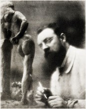 Old photo / portrait of the world famous artist, Henri Matisse sculpturing