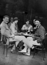 PAMPLONA, SPAIN - July 1925 - Ernest Hemingway with Lady Duff Twysden, Hadley Hemingway, and three unidentified people at a cafe in Pamplona, Spain, d