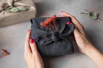 Female hands holding Furoshiki gift