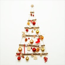 Handmade Christmas tree hangs on a white wall. Alternative decoration, eco-friendly christmas, civic awareness.