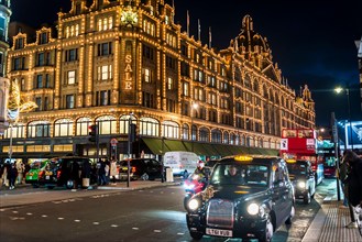 Harrods, a Luxury Department Store and busy traffic on Knightsbridge at Christmas time, London, England, UK