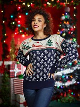 Portrait of an African America woman in ugly Christmas sweater looking at camera with hands on hips