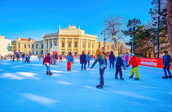 VIENNA, AUSTRIA - FEBRUARY 17, 2019: People enjoy winter skating on large ice rink on Rathausplatz, on February 17 in Vienna, Austria