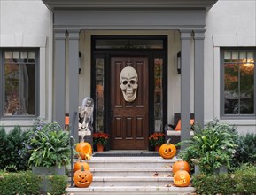 Halloween decorations on front porch and steps of house