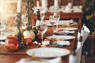 Table setting, fine dining and celebration of Christmas dinner on a patio of a house. Food, party and dining table ready for a feast, Thanksgiving