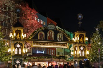 Night atmosphere in front of beautiful arched entrance of Weihnachtsmarkt, Christmas Market in Köln, at Alter Markt, famous marketplace nearby Cologne