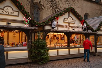 Cologne, Germany - December 13, 2022: different types of christmas goodies at Christmas market. joyful atmosphere and decorations at fair, preparations for New Year and Christmas