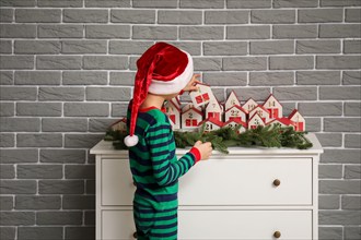 Little boy with Christmas advent calendar at home