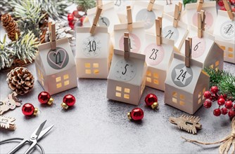 Preparation of christmas advent calendar. Advent calendar, Christmas gifts and decorations on a concrete background.