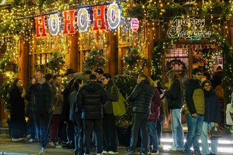 London, UK. 14th November, 2024. The Churchill Arms in Kensington switches on its festive light display with the external walls covered in over 80 Christmas trees and decorations. The pub attracts man...