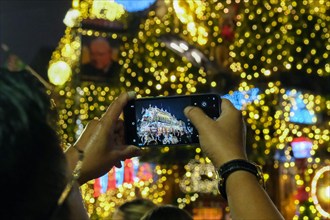 London, UK. 14th November, 2024. The Churchill Arms in Kensington switches on its festive light display with the external walls covered in over 80 Christmas trees and decorations. The pub attracts man...