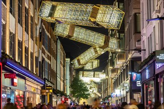 LONDON, UK - 9TH NOV 2024: A view along Carnaby Street at Christmas showing the decorations and lights. People can be seen below the decorations along