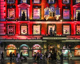 London, UK. 18th Nov, 2024. The annual 'advent calendar' facade decorations and 2024 display glows in festive red on the Fortnum and Mason building in Piccadilly. Christmas Lights, baubles and elabora...