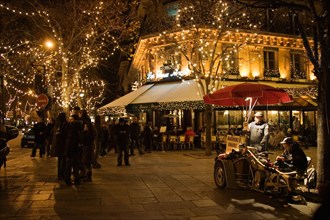 Roasted chestnut street seller outside Les Deux Magots Cafe and Restaurant Boulevard St Germain Paris France