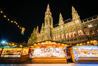 Christmas Market and Rathaus at night, at Rathausplatz, in Vienna, Austria.