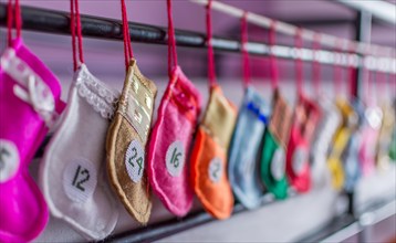 Handmade advent Christmas calendar of mini colorful Santa stockings