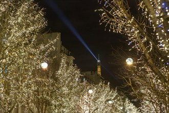 Christmas lights in Avenue Montaigne in Paris with the Eiffel Tower in the background