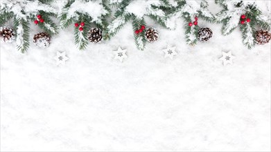 Christmas Background with snow, white wooden christmas stars, snowy pine cones, red berries and natural fir tree twigs. Top View.