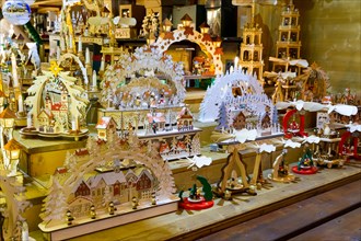 Wooden crafted toys and christmas decorations on stale on a booth at the traditional christmas market of Strasbourg, France, Europe.