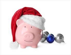 Piggy bank with Santa hat on white background