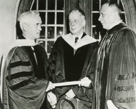 Scottish physician and microbiologist Alexander Fleming (left) receives an honorary degree from Thomas S. Gates, President of the University of Pennsylvania while Dr. Alfred Newton Richards looks on, ...