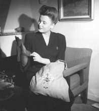 Nylon stockings in the 1940s. A young woman is holding a nylon stocking in her hand. The nylon stocking was very popular in the 1940s, a trendy accessory that was very expensive to buy during time of ...